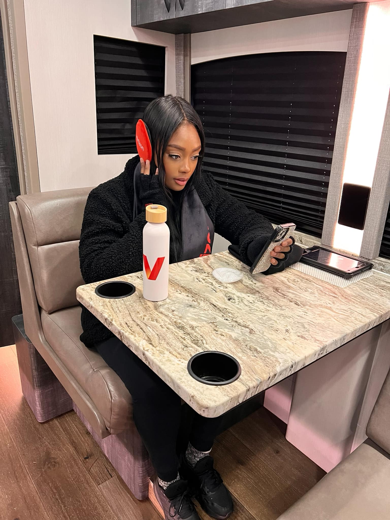 King Micah sitting inside the Verizon Wireless Dallas tour bus during the Road to the NFL Super Bowl 2025 activation.